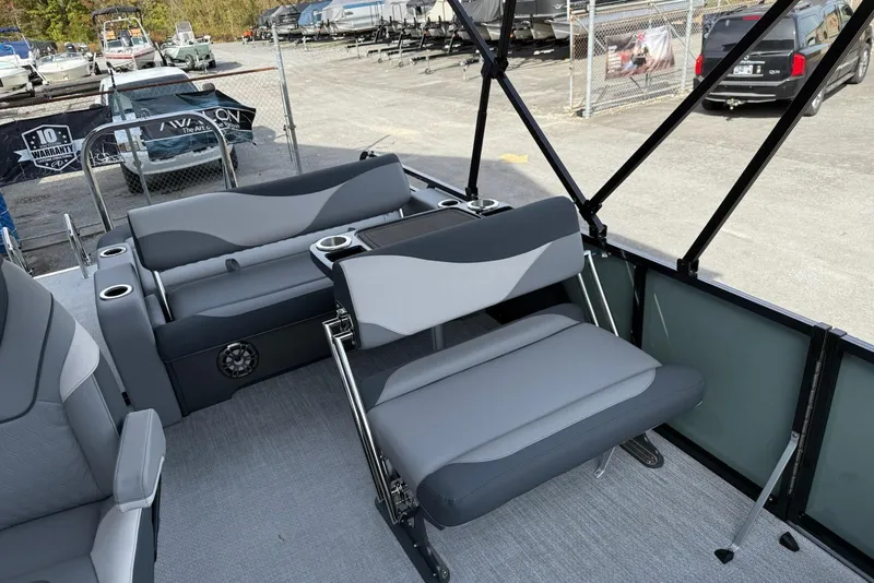 Slide: The Image of 2026 Avalon 2385 LSZ Entertainer boat interior with gray seating and cup holders. - 7