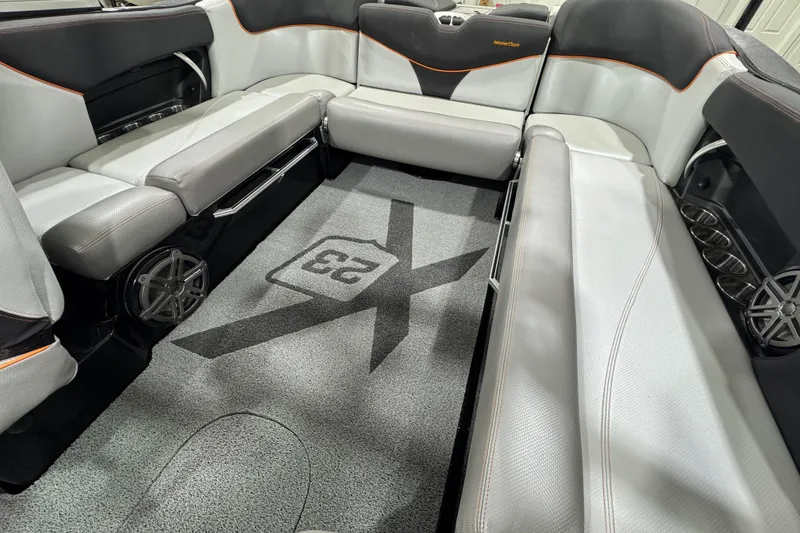Slide: The Image of 2017 MasterCraft X23 interior with gray seating and custom carpet design. - 12