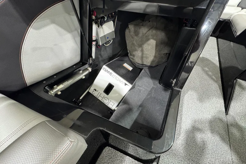 Slide: The Image of 2017 MasterCraft X23 interior storage compartment with equipment and upholstery details. - 13