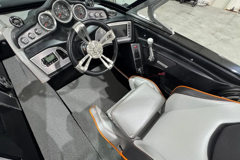 Slide: The Image of 2017 MasterCraft X23 boat interior with modern dashboard and steering wheel. - 14