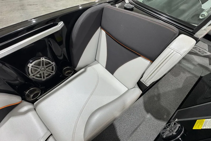 Slide: The Image of 2017 MasterCraft X23 boat interior with stylish seating and built-in speaker system. - 19