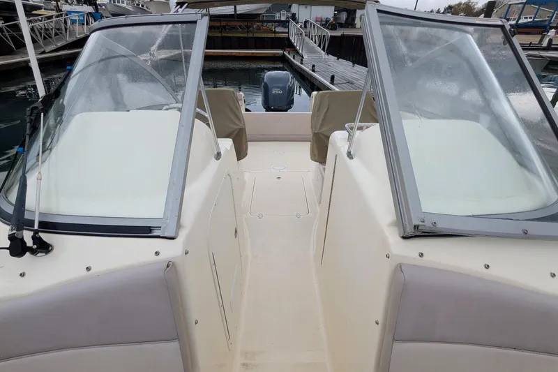 Slide: The Image of 2009 Scout 245 Dorado boat with dual windshields docked at marina. - 12