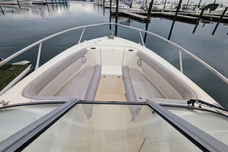 Slide: The Image of 2009 Scout 245 Dorado boat with spacious seating, docked in a calm marina. - 13