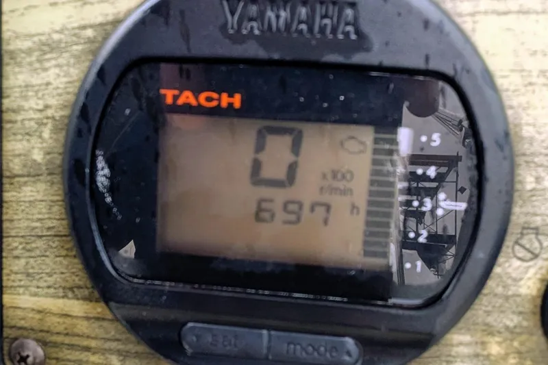 Slide: The Image of Yamaha tachometer displaying 697 hours on a 2009 Scout 245 Dorado boat. - 16