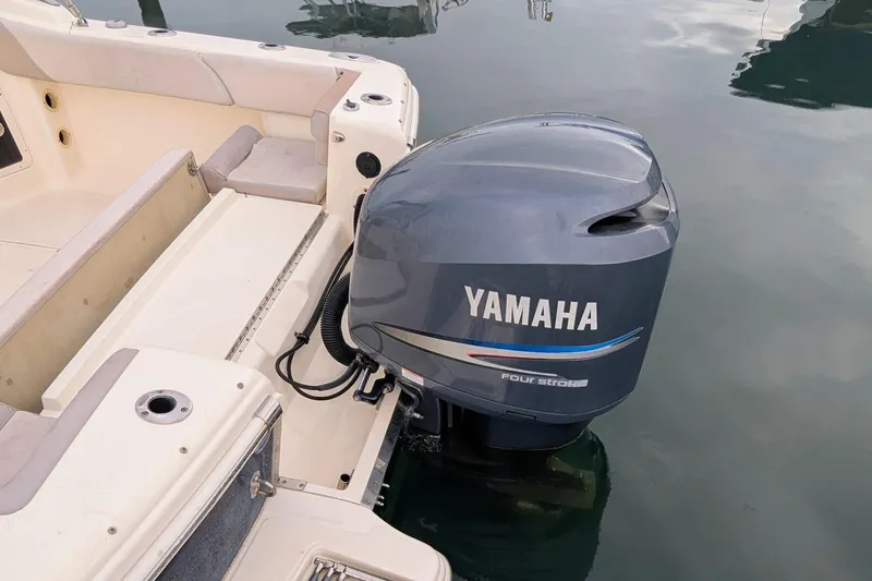 Slide: The Image of 2009 Scout 245 Dorado boat with Yamaha four-stroke outboard motor on calm water. - 5