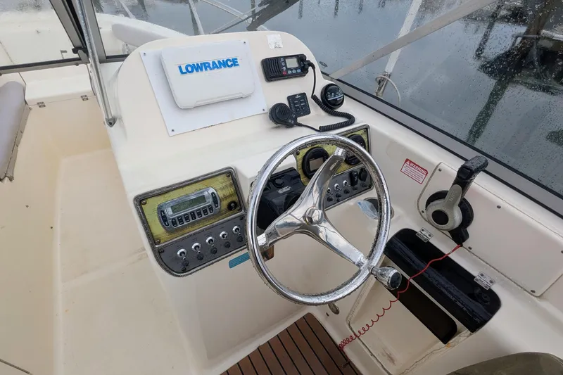 Slide: The Image of 2009 Scout 245 Dorado boat helm with steering wheel and navigation equipment. - 7