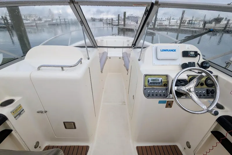 Slide: The Image of 2009 Scout 245 Dorado boat cockpit with steering wheel and navigation equipment. - 8