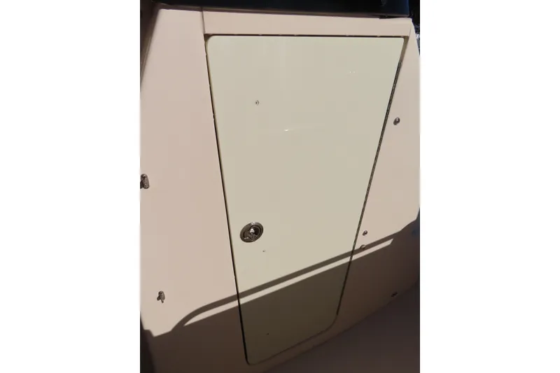 Slide: The Image of 2019 Grady-White Fisherman 257 boat compartment door in sunlight. - 14