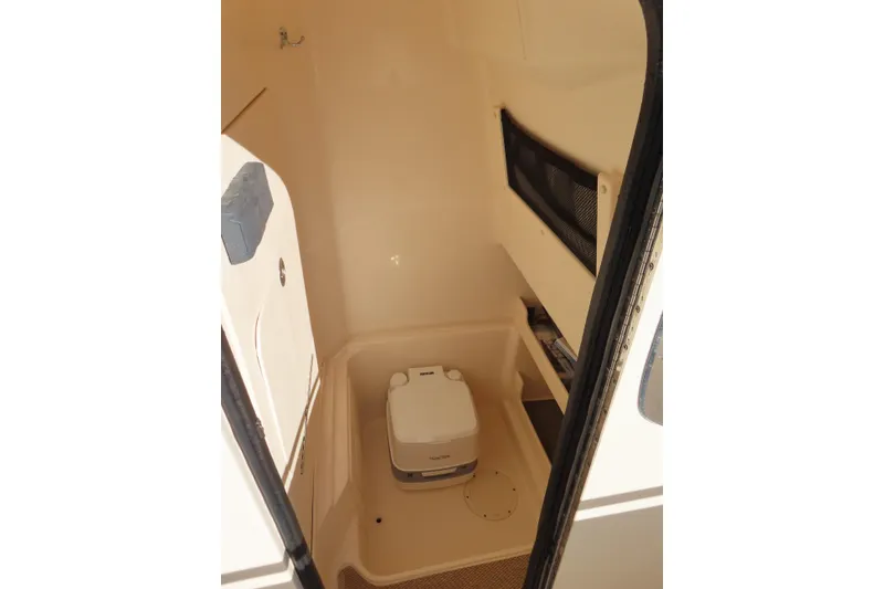 Slide: The Image of 2019 Grady-White Fisherman 257 boat interior with compact toilet and storage. - 15