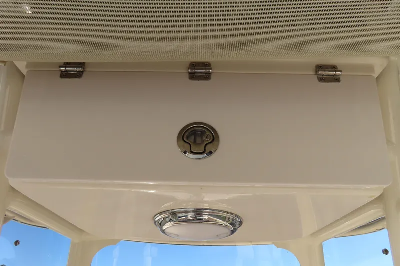 Slide: The Image of 2019 Grady-White Fisherman 257 boat storage compartment with latch and light. - 20