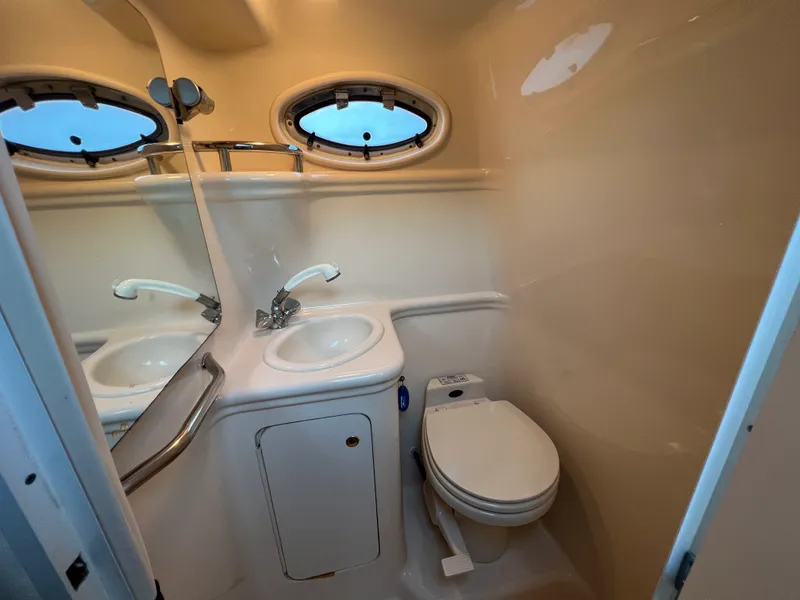 Slide: The Image of Bathroom interior of 2001 Sea Ray 260 Sundancer boat with sink and toilet. - 12