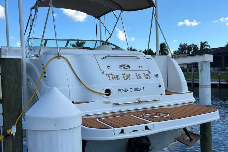 Slide: The Image of 2001 Sea Ray 260 Sundancer docked in Punta Gorda, Florida, with custom nameplate. - 2