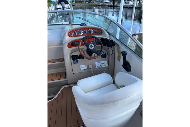 Slide: The Image of Cockpit of 2001 Sea Ray 260 Sundancer with steering wheel and control panel. - 3