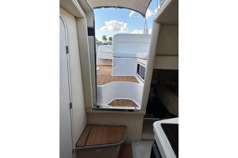 Slide: The Image of Interior view of 2001 Sea Ray 260 Sundancer boat with wooden steps and seating area. - 8