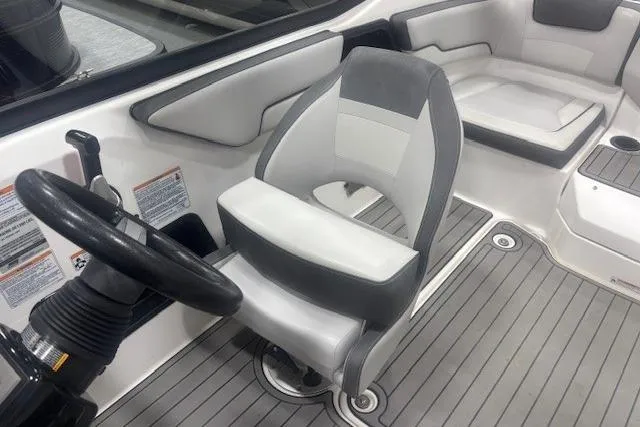 Slide: The Image of 2019 Yamaha Boats AR190 interior with gray and white seating, steering wheel, and sleek design. - 11