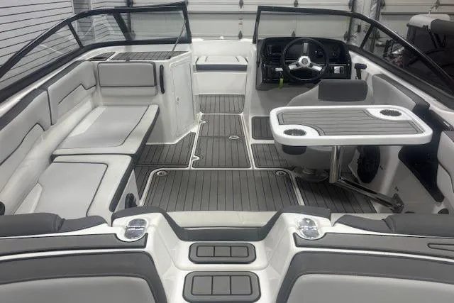 Slide: The Image of 2019 Yamaha Boats AR190 interior with seating, steering wheel, and table. - 17