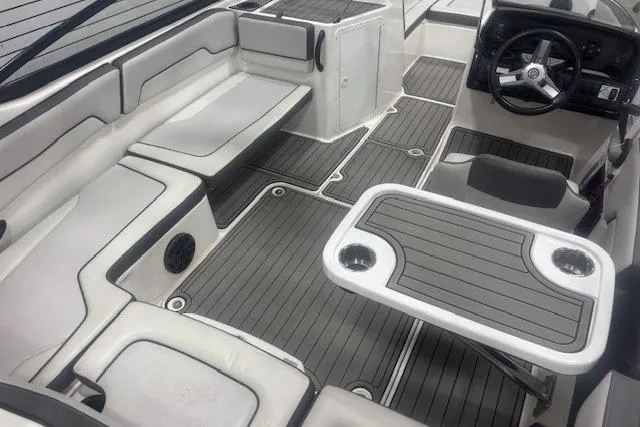 Slide: The Image of 2019 Yamaha Boats AR190 interior with seating, steering wheel, and table. - 19