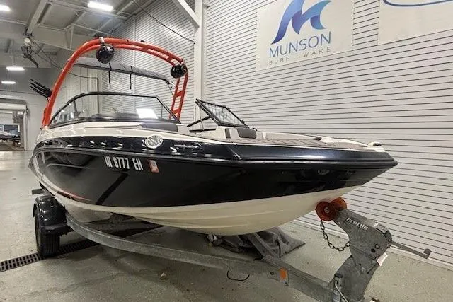 Slide: The Image of 2019 Yamaha Boats AR190 on trailer in showroom, Munson Surf Wake sign visible. - 22
