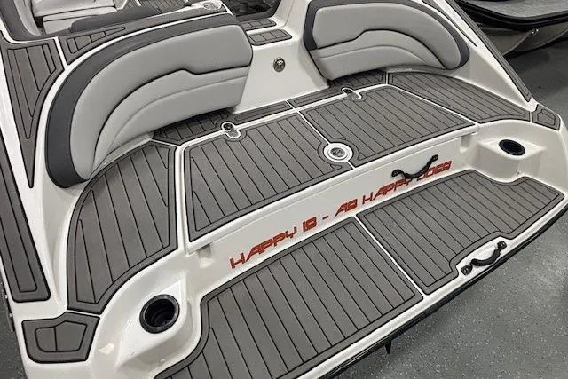 Slide: The Image of 2019 Yamaha Boats AR190 swim platform with cushioned seating and gray decking. - 23