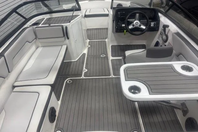 Slide: The Image of 2019 Yamaha Boats AR190 interior with gray seating, steering console, and table. - 28