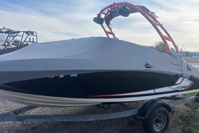 Slide: The Image of 2019 Yamaha AR190 boat with cover on trailer, featuring red wakeboard tower. - 3
