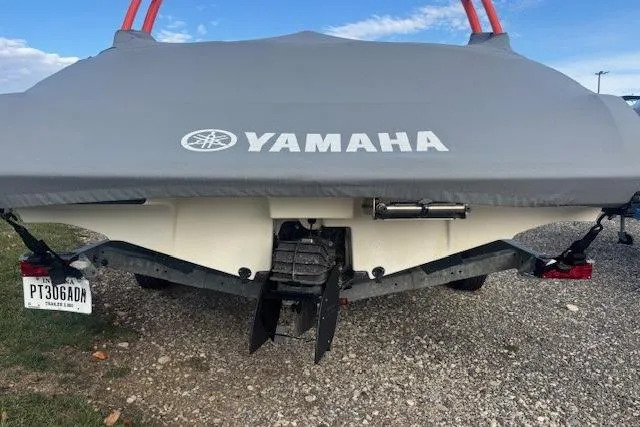 Slide: The Image of 2019 Yamaha AR190 boat with cover, rear view on gravel surface. - 31