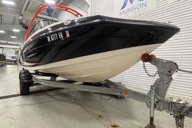 Slide: The Image of 2019 Yamaha AR190 boat on trailer in showroom, Munson Marine sign visible. - 35