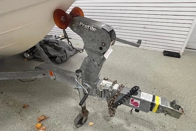 Slide: The Image of Trailer hitch of a 2019 Yamaha Boats AR190, featuring a Profile winch and safety chains. - 40