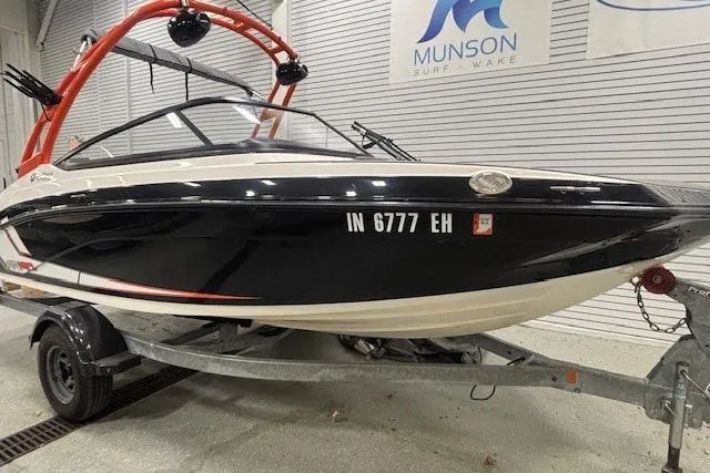 Slide: The Image of 2019 Yamaha AR190 boat on trailer in showroom, Munson Surf Wake sign visible. - 42