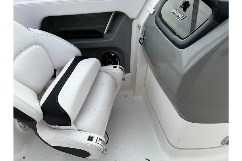 Slide: The Image of 2019 Chaparral 246 SSi boat interior with white seating and dashboard. - 17
