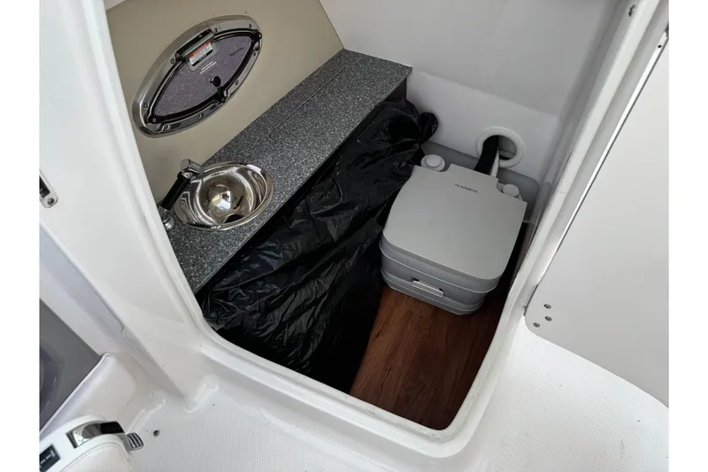 Slide: The Image of 2019 Chaparral 246 SSi boat interior with sink and portable toilet. - 18