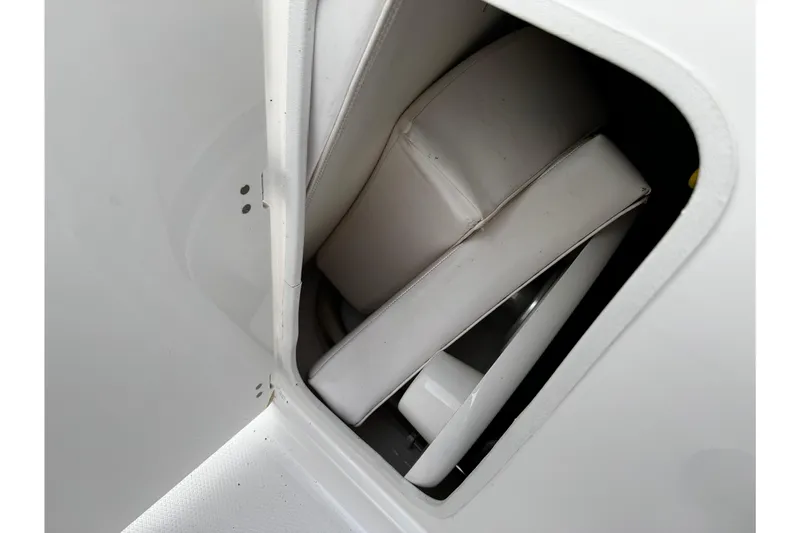 Slide: The Image of Storage compartment with white cushions in 2019 Chaparral 246 SSi boat. - 20