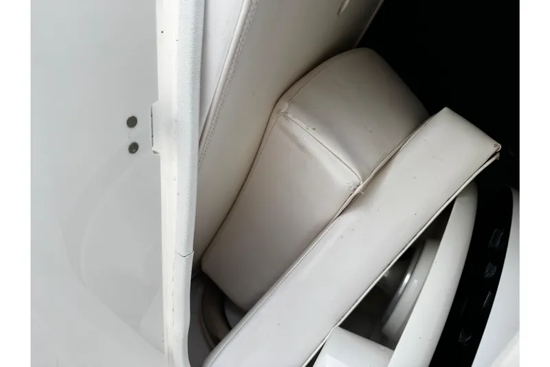 Slide: The Image of 2019 Chaparral 246 SSi boat interior with white cushioned seating. - 21