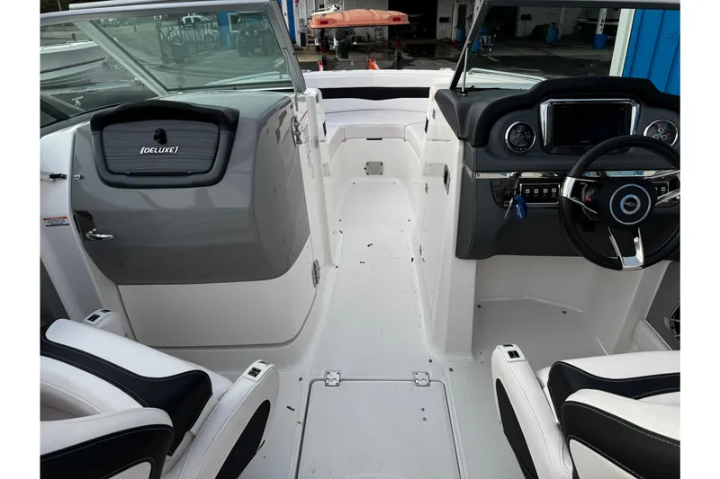 Slide: The Image of 2019 Chaparral 246 SSi boat interior with deluxe dashboard and seating. - 23