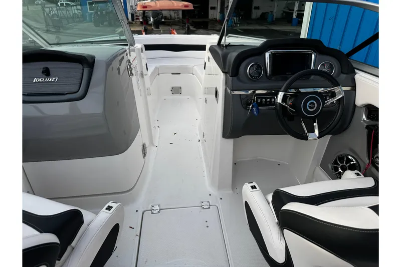 Slide: The Image of 2019 Chaparral 246 SSi boat interior with steering wheel and dashboard controls. - 24