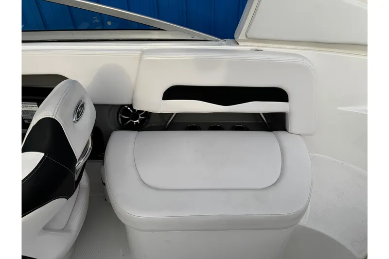 Slide: The Image of 2019 Chaparral 246 SSi boat interior with white seating and storage compartment. - 26