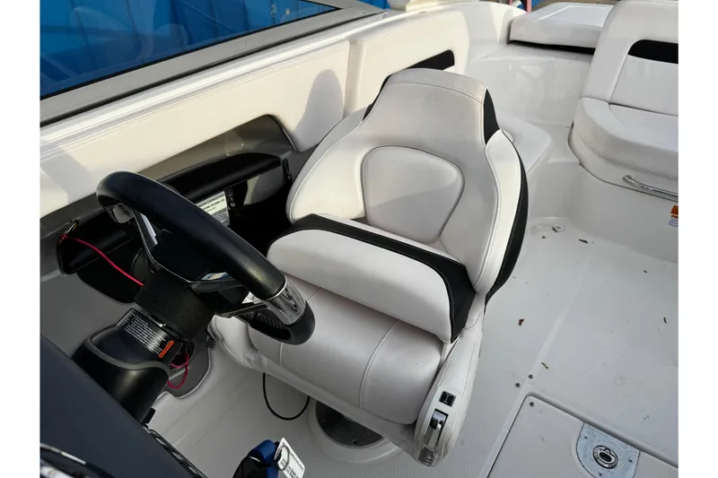 Slide: The Image of 2019 Chaparral 246 SSi boat interior with white captain's seat and steering wheel. - 27