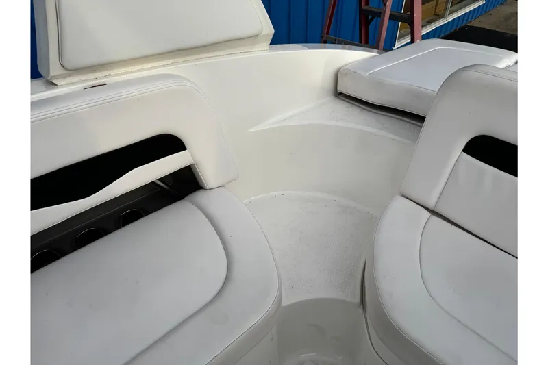Slide: The Image of 2019 Chaparral 246 SSi boat interior with white seating and cup holders. - 28