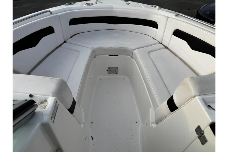 Slide: The Image of 2019 Chaparral 246 SSi boat interior with white cushioned seating. - 32