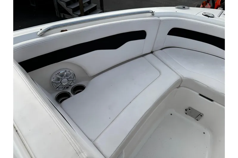 Slide: The Image of 2019 Chaparral 246 SSi boat interior with white seating and speaker system. - 33