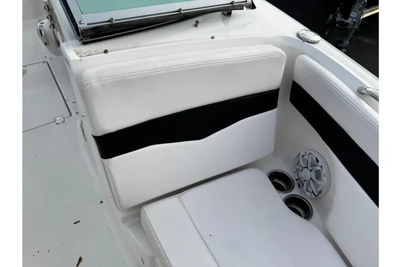 Slide: The Image of 2019 Chaparral 246 SSi boat interior with white seating and speaker. - 35