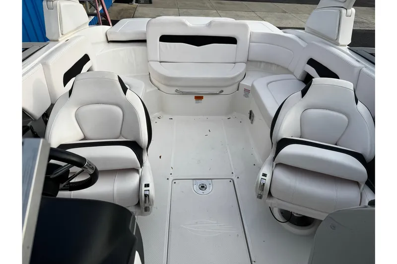 Slide: The Image of 2019 Chaparral 246 SSi boat interior with white seating and steering wheel. - 37
