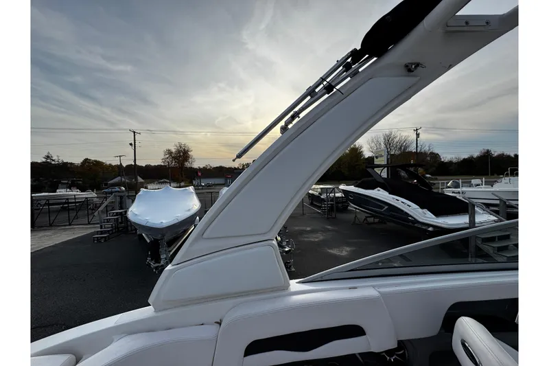 Slide: The Image of 2019 Chaparral 246 SSi boat in a showroom with other boats, under a cloudy sky. - 39