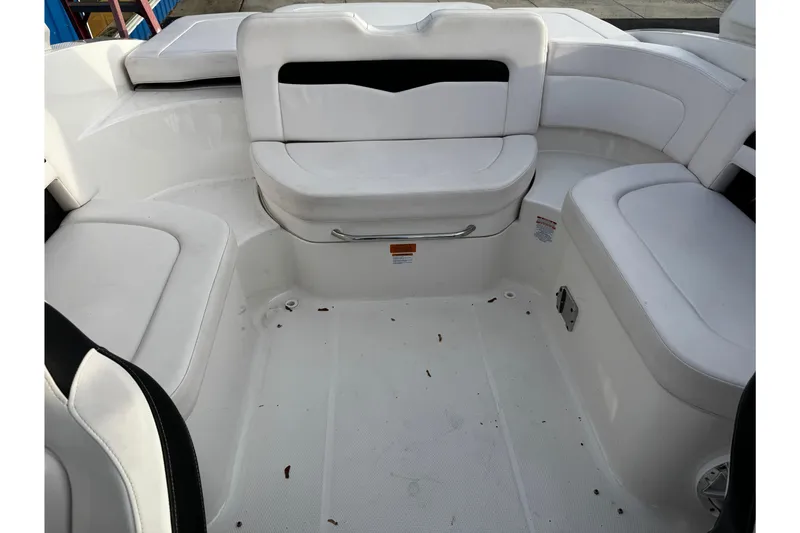 Slide: The Image of 2019 Chaparral 246 SSi boat interior with white seating and spacious layout. - 44