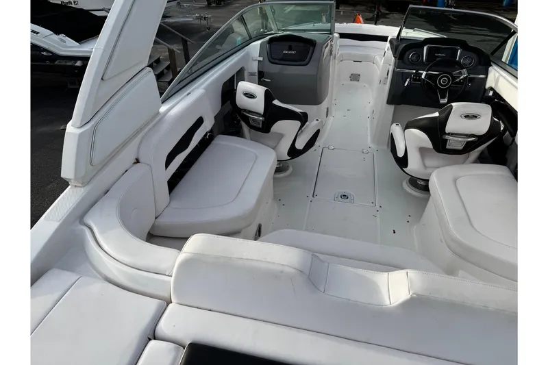 Slide: The Image of 2019 Chaparral 246 SSi boat interior with white seating and modern dashboard. - 45