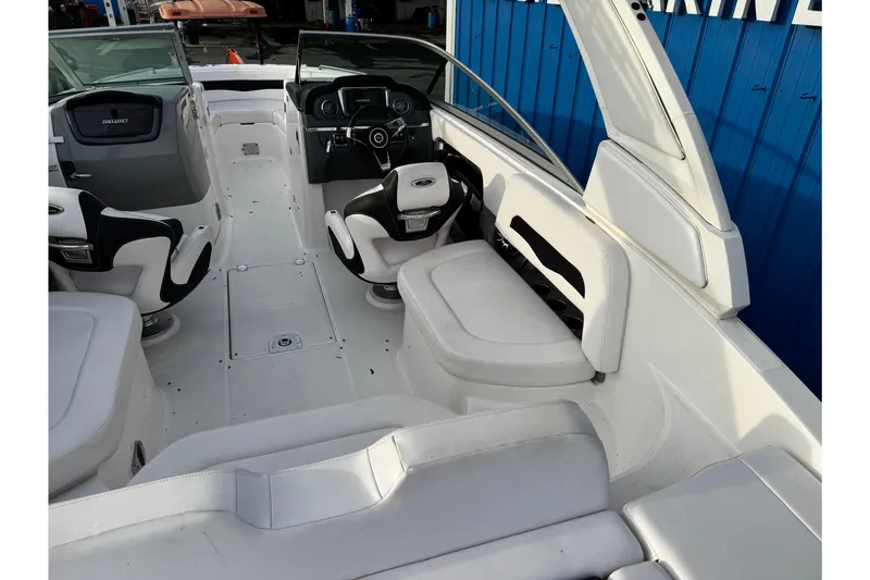 Slide: The Image of 2019 Chaparral 246 SSi boat interior with white seating and modern dashboard. - 46