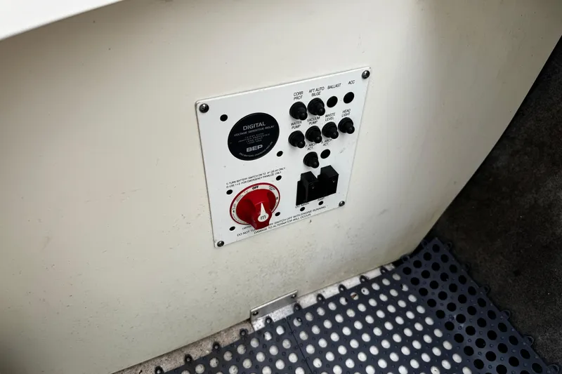 Slide: The Image of Control panel on 2019 Chaparral 246 SSi boat with switches and red dial. - 5