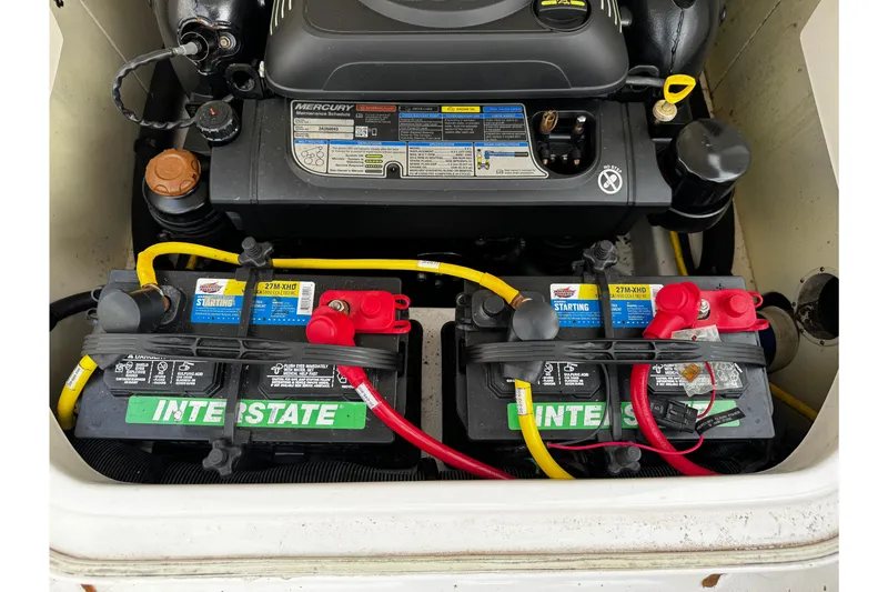Slide: The Image of Engine compartment of 2019 Chaparral 246 SSi with Interstate batteries and Mercury components. - 52