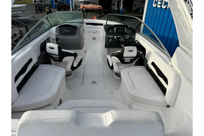 Slide: The Image of 2019 Chaparral 246 SSi boat interior with white seating and modern dashboard. - 6