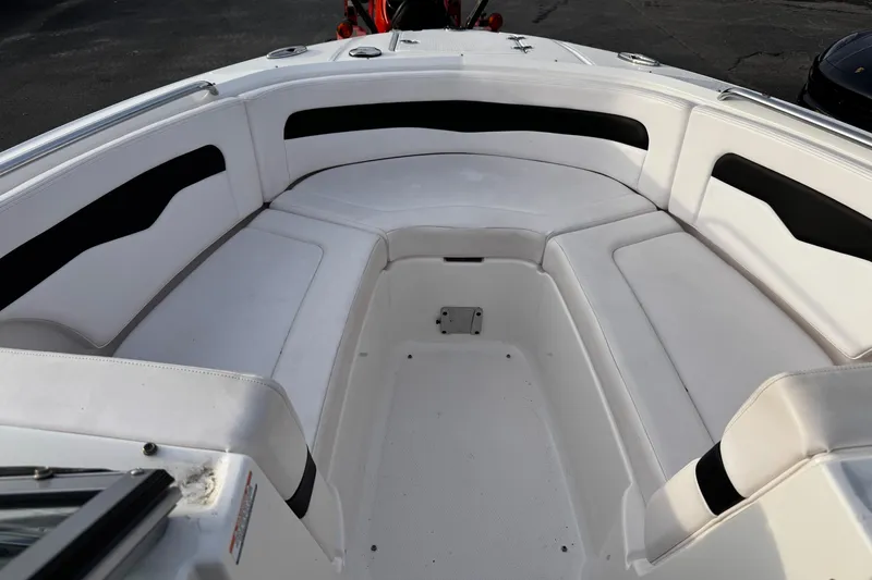 Slide: The Image of 2019 Chaparral 246 SSi boat interior with white cushioned seating. - 7
